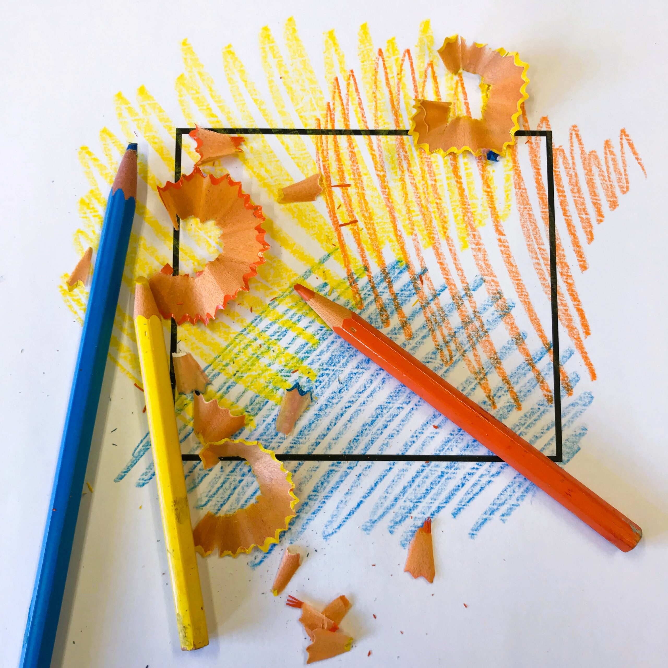 colouring pencils and sharpenings over the top of a coloured in square
