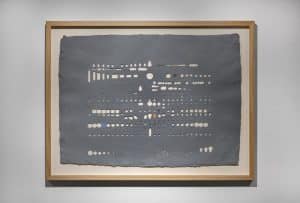 a piece of artwork made with punched holes 