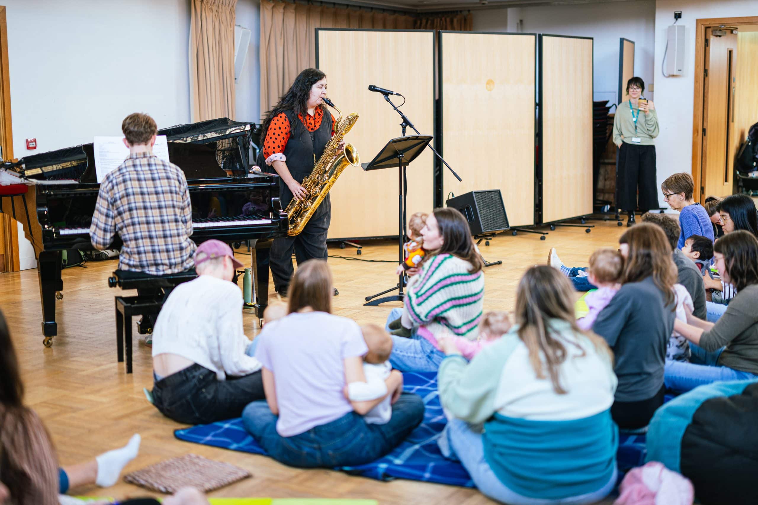 Babies and their carers listening to piano and saxophone